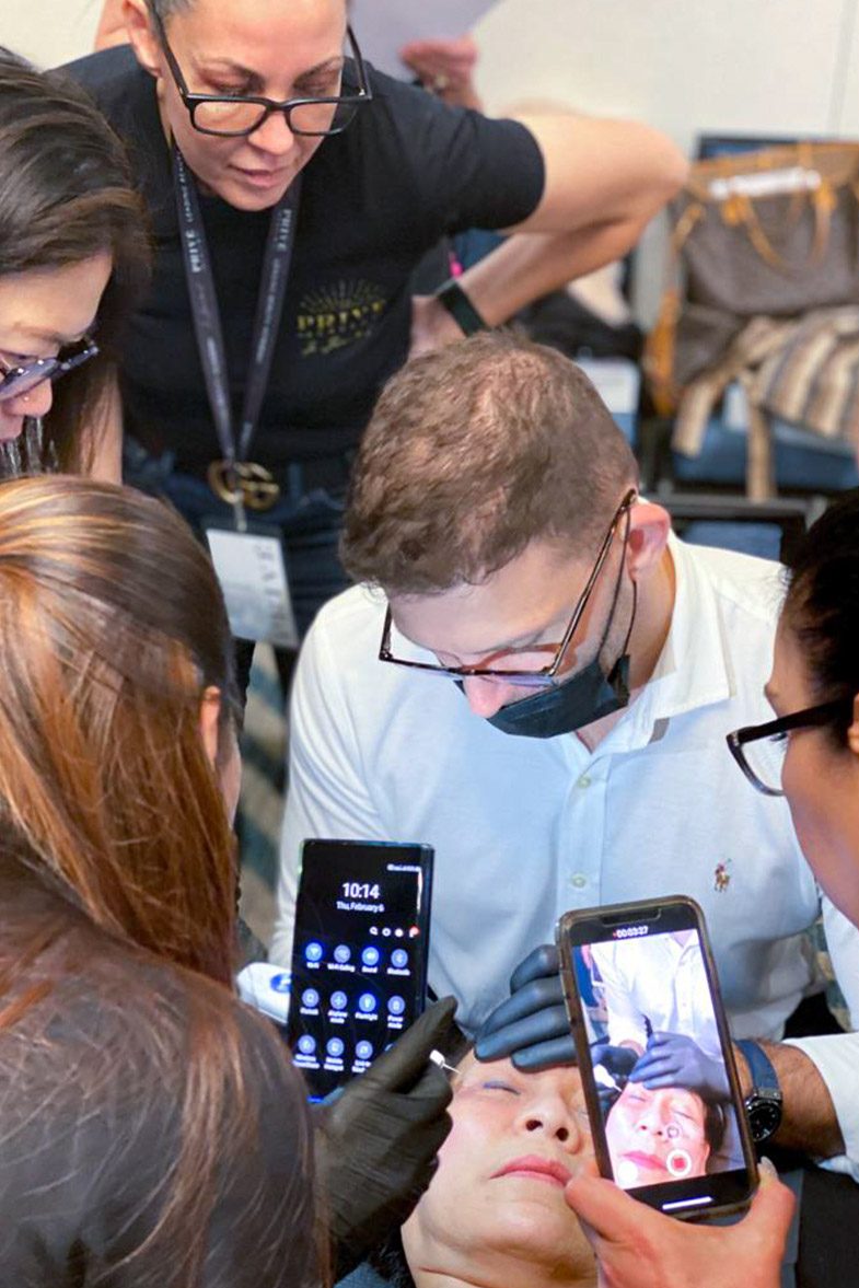 Students filming a live demonstration on their phones